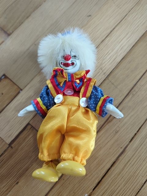porcelain clown doll yellow pants
